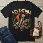 Black crewneck t-shirt featuring a golden retriever hiking graphic with mountains, trees, and the text Adventure Never Gets Old.