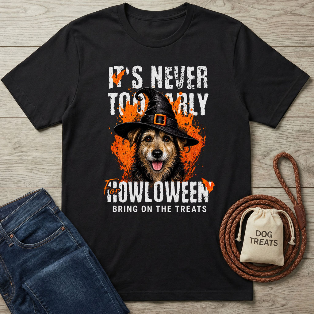 Black crewneck t-shirt featuring a dog in a witch hat with orange Halloween graphics and the text It's Never Too Early For Howloween.