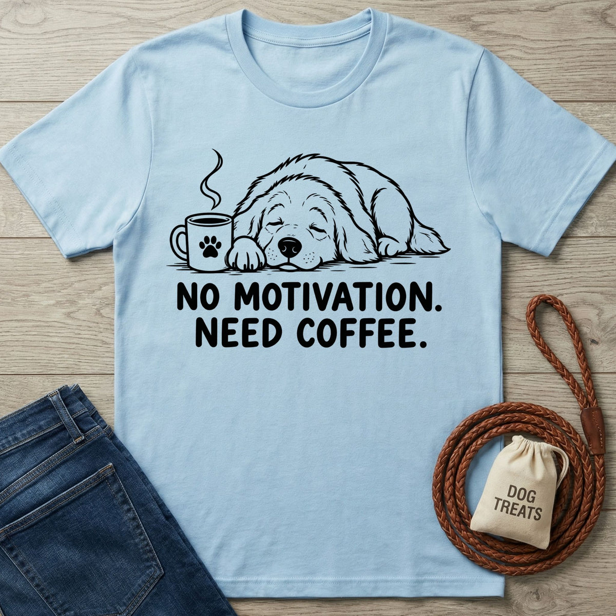 Light blue cotton crewneck t-shirt featuring a line art graphic of a sleeping dog with a coffee cup and text.
