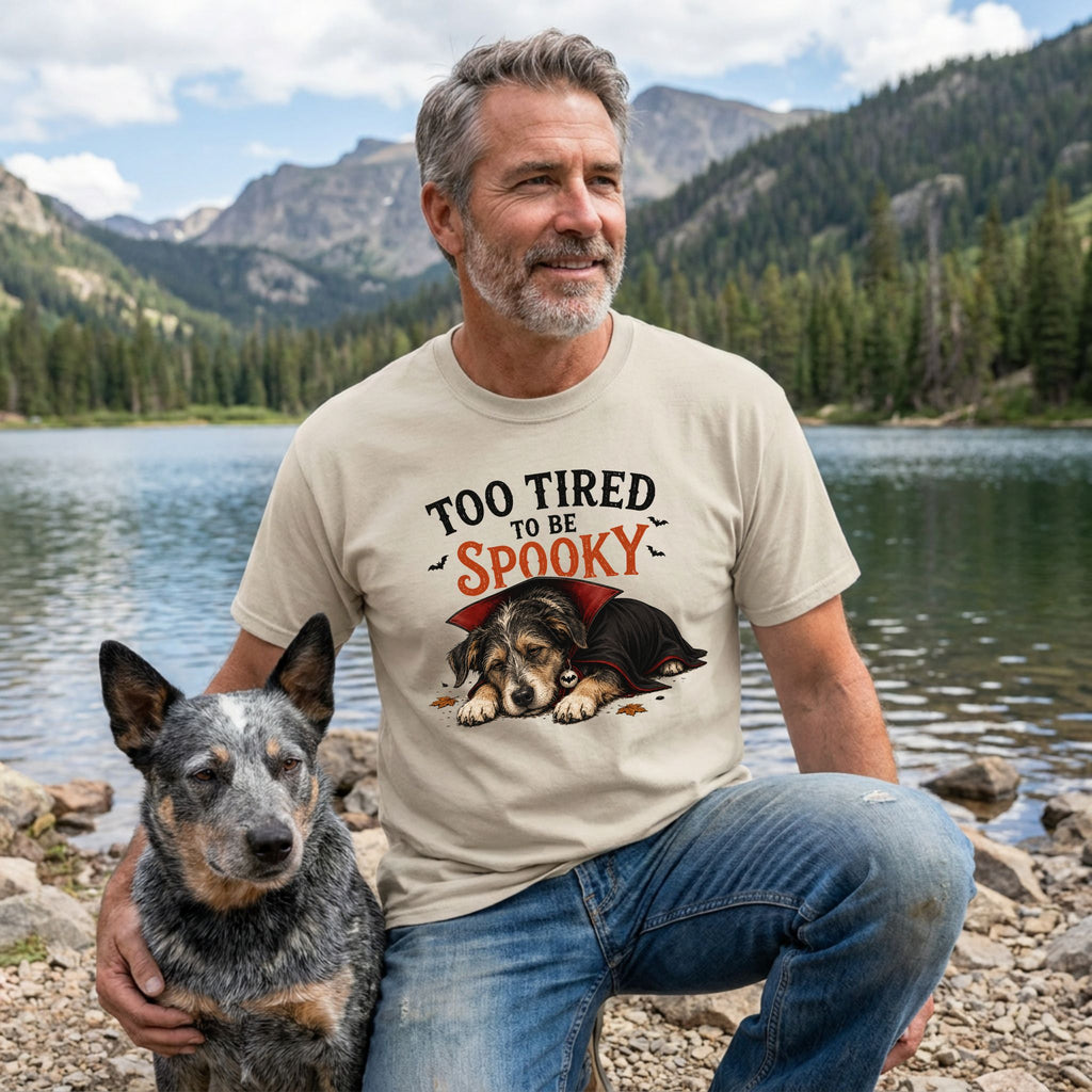Beige crewneck t-shirt featuring a sleeping vampire dog graphic with text reading Too Tired To Be Spooky.