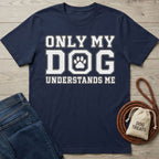 Navy blue cotton t-shirt with white Only My Dog Understands Me text and a paw print graphic on a wooden background.