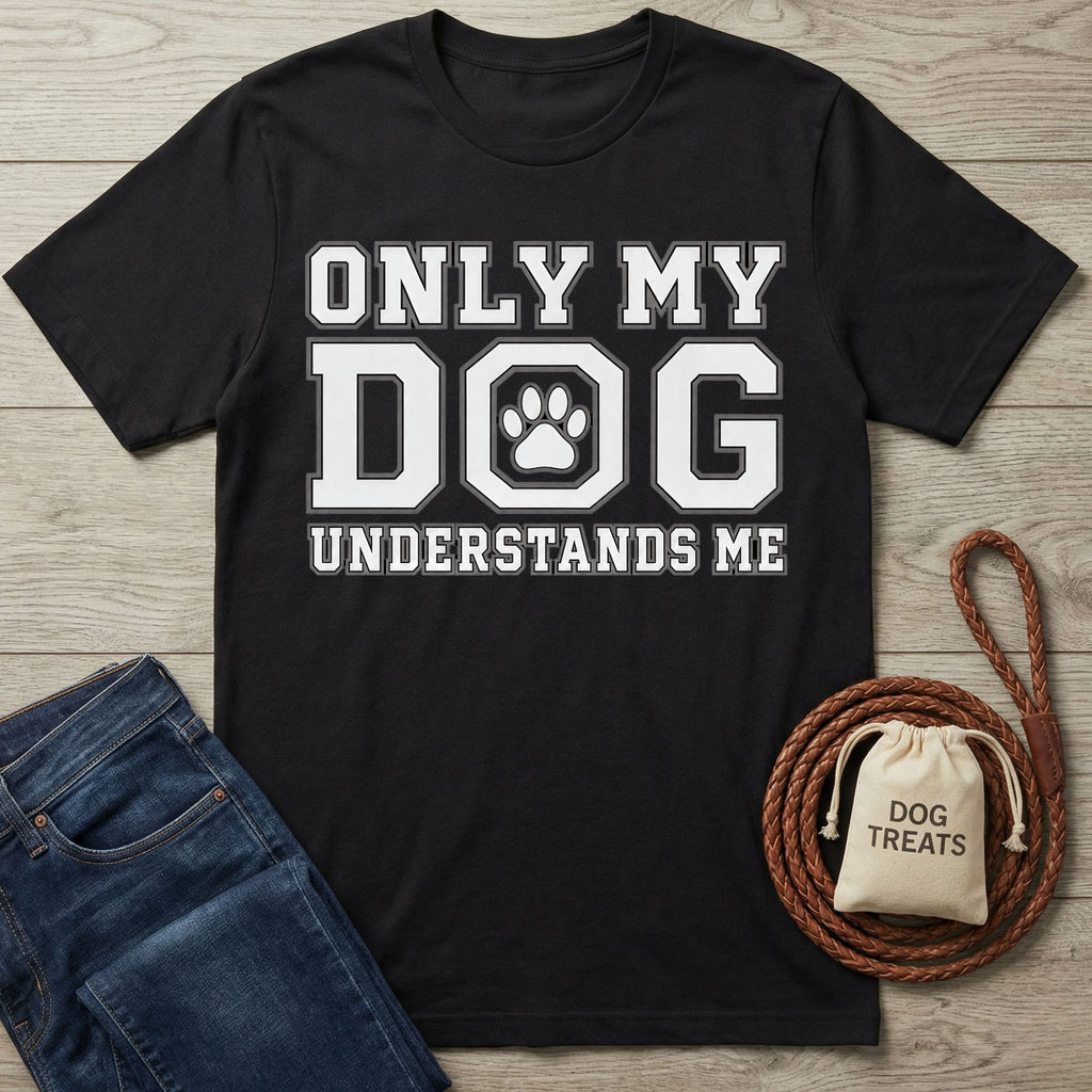 Black cotton t-shirt featuring white Only My Dog Understands Me text with a paw print graphic on a wooden background.