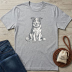 Grey crewneck t-shirt featuring a detailed black and white illustration of a sitting dog with a rope toy and tennis ball.