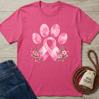 Pink T-shirt featuring a watercolor paw print and breast cancer awareness ribbon with delicate floral accents.