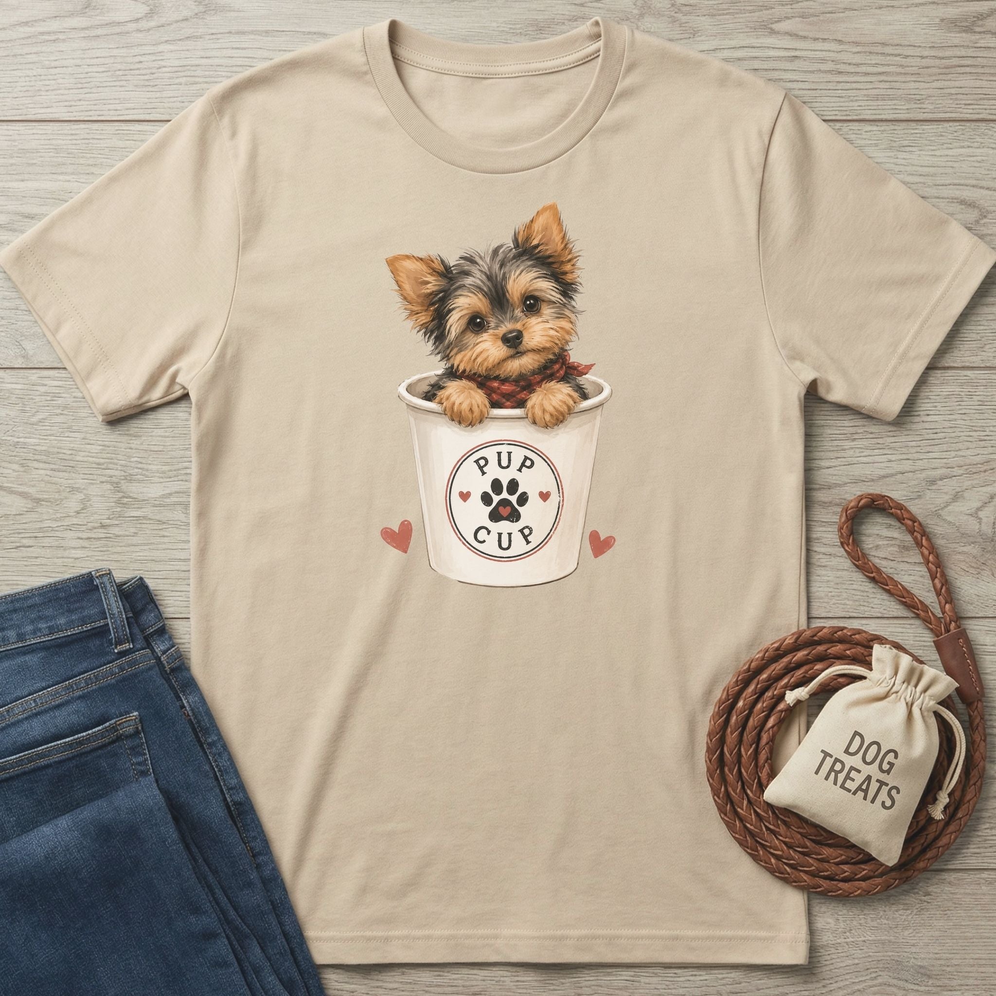 Beige crewneck t-shirt featuring a cute Yorkshire Terrier inside a Pup Cup graphic with paw print and heart details.