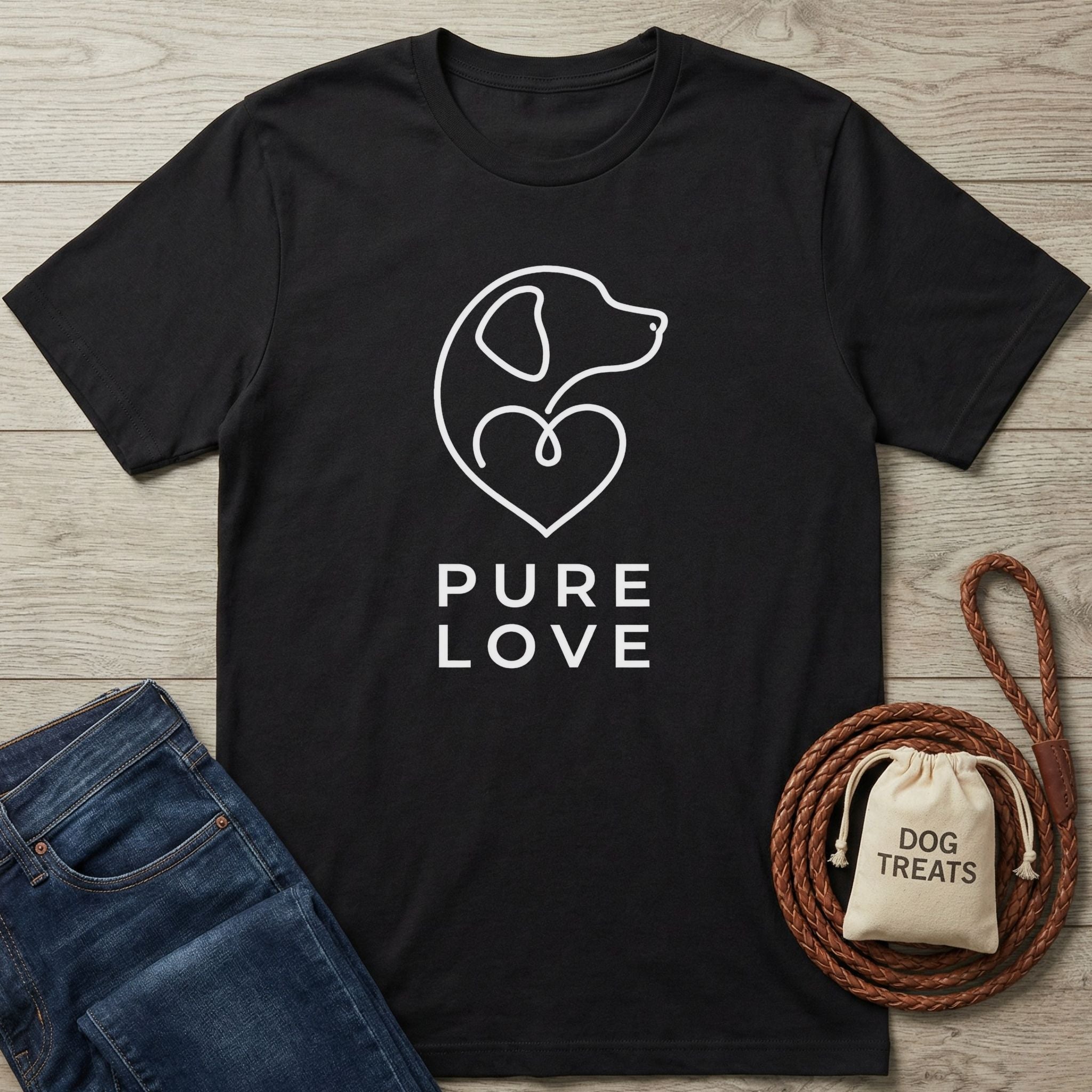 Black Gildan Softstyle® 64000 tee with "Pure Love" and dog outline design, next to jeans and dog treats.