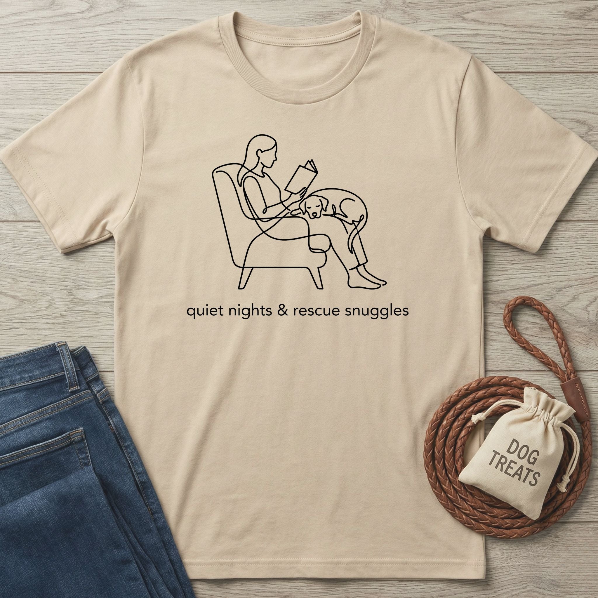 Beige Gildan Softstyle® t-shirt with "quiet nights & rescue snuggles" and line art of a person reading with a dog.