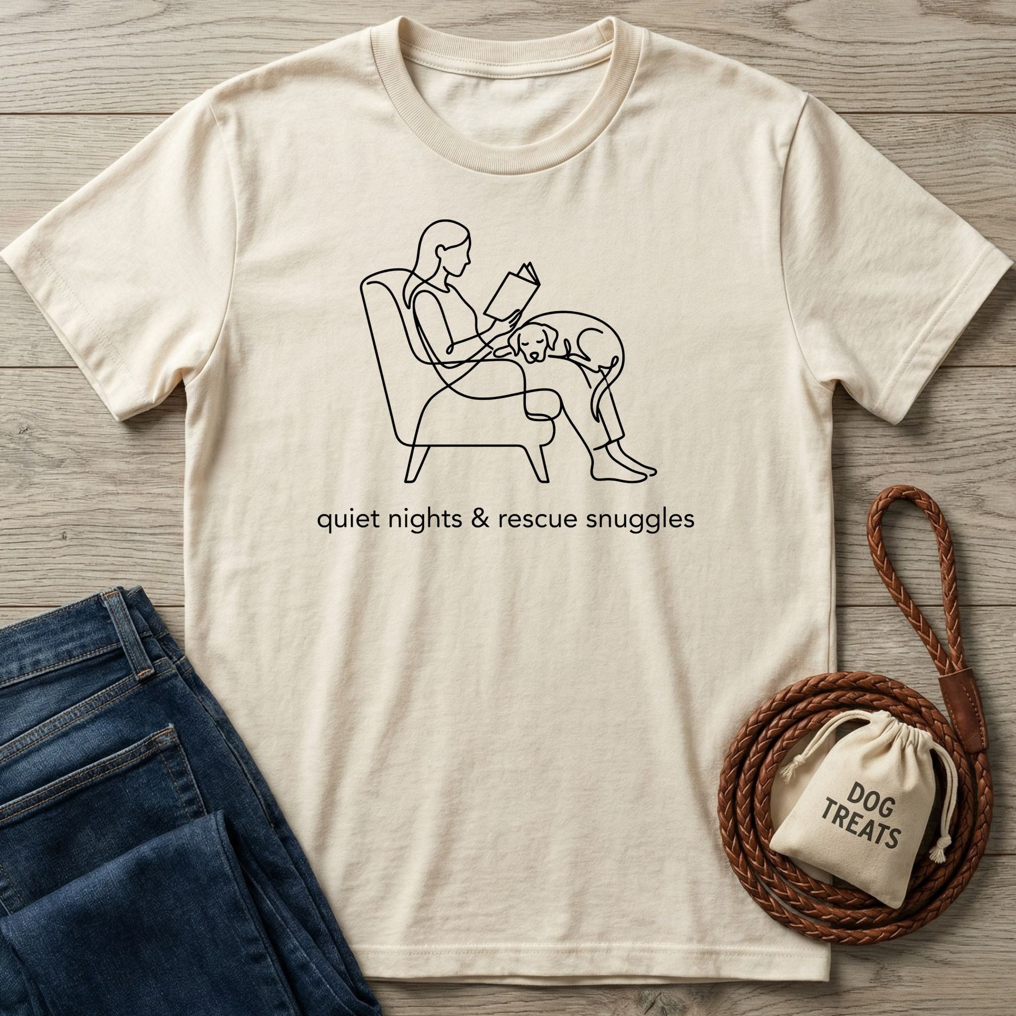 Cream Gildan Softstyle® T-shirt with line art of a person reading with a rescue dog, "quiet nights & rescue snuggles" text.