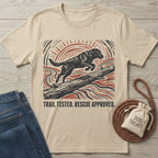 Beige crewneck t-shirt featuring a woodblock-style print of a dog jumping over a log with red and black sun rays.