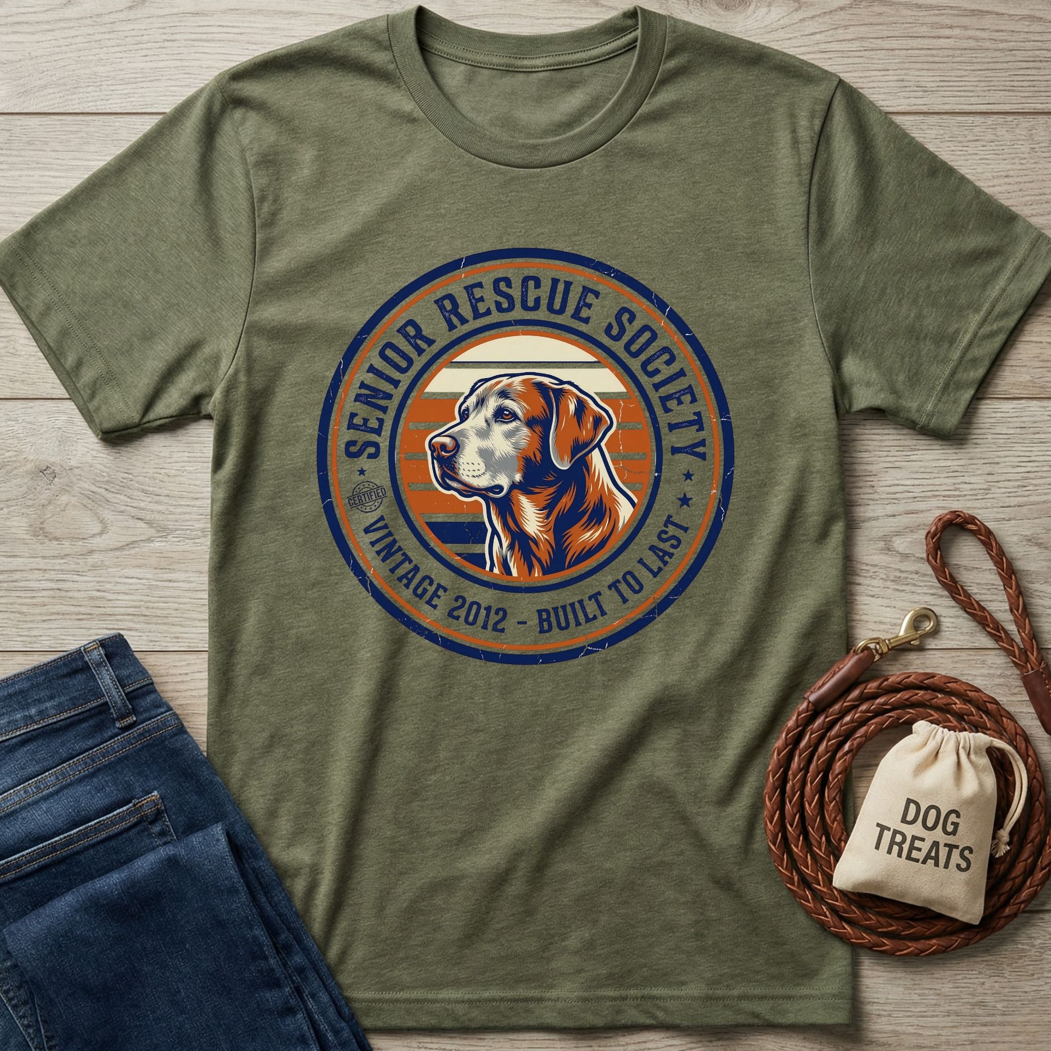 Olive green Senior Rescue Society t-shirt with a vintage dog graphic, next to jeans and a dog leash.