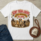 White crewneck t-shirt featuring a vintage-style graphic of four dogs in a mountain landscape with the text Sent From Above.