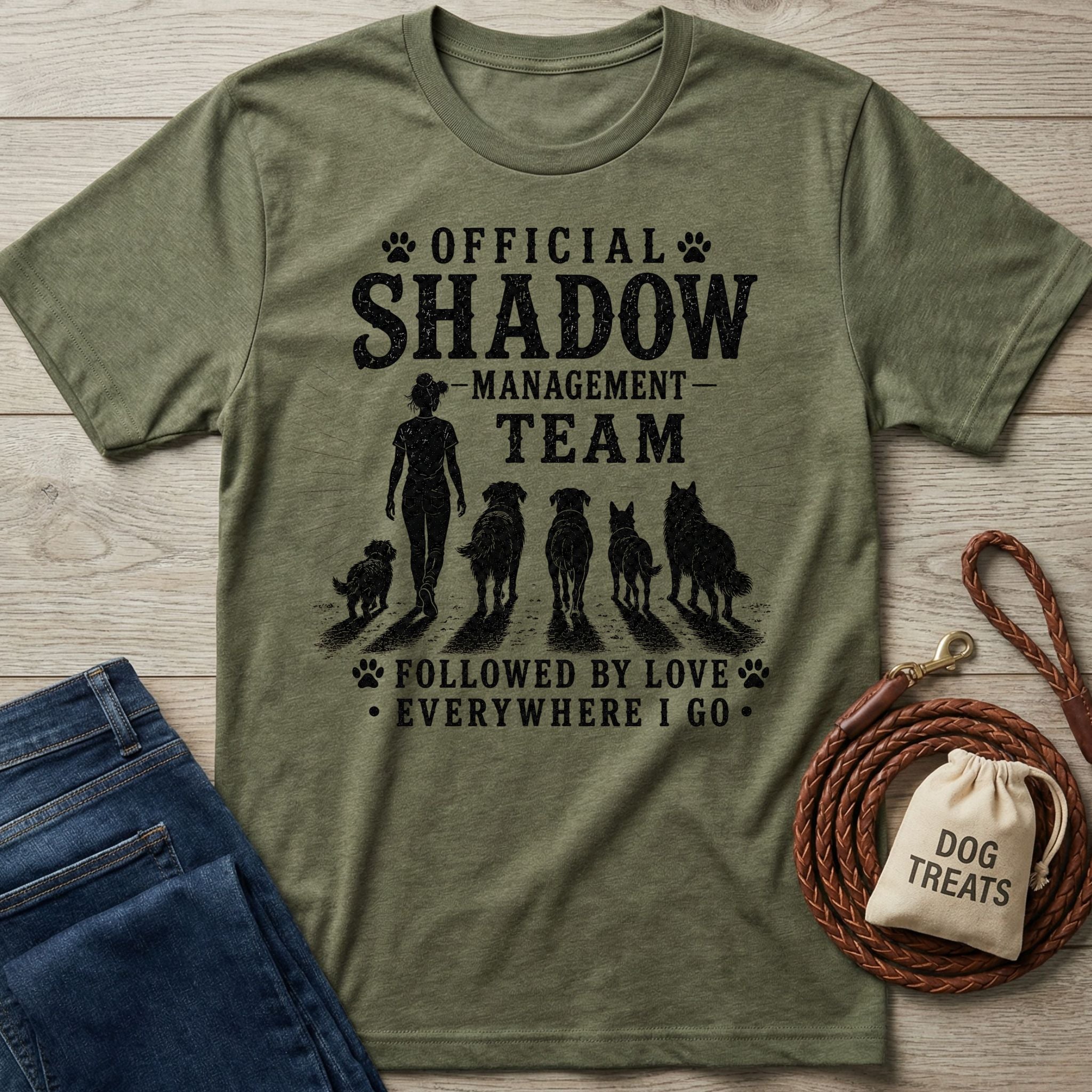 Olive green heather t-shirt with "Official Shadow Management Team" graphic featuring a person and five dogs.