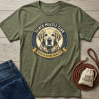 Olive green Silver Muzzle Club t-shirt with a Golden Retriever graphic, next to jeans, a leash, and dog treats.