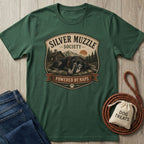 Dark green "Silver Muzzle Society" t-shirt with a sleeping senior dog graphic, next to jeans and dog treats.