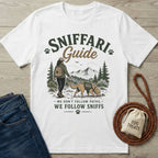 White crewneck t-shirt featuring a hiker and dog graphic with Sniffari Guide text on a wooden background.
