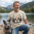 Man wearing a beige crewneck t-shirt featuring a spooky campfire graphic with skeletons and ghost dogs by a lake.