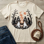 Cream-colored cotton t-shirt featuring skeletons and ghost dogs sitting around a campfire under a blood moon.