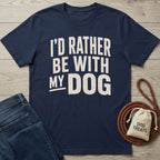 Navy blue crewneck t-shirt with distressed white text reading I'D RATHER BE WITH MY DOG, displayed on a wooden background.