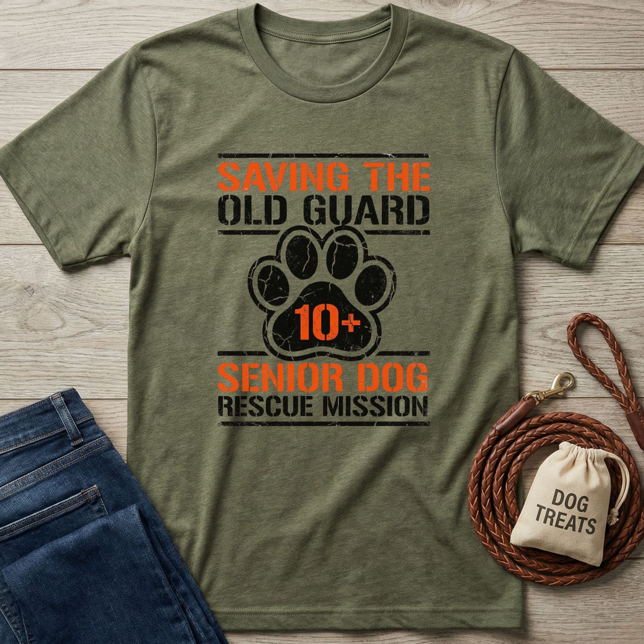 Olive green "Saving The Old Guard Senior Dog Rescue Mission" t-shirt with a paw print and "10+" design.