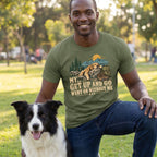 Man wearing an olive green crewneck T-shirt with a graphic of a sleeping dog, mountains, and the text My Get Up And Go Went On Without Me.
