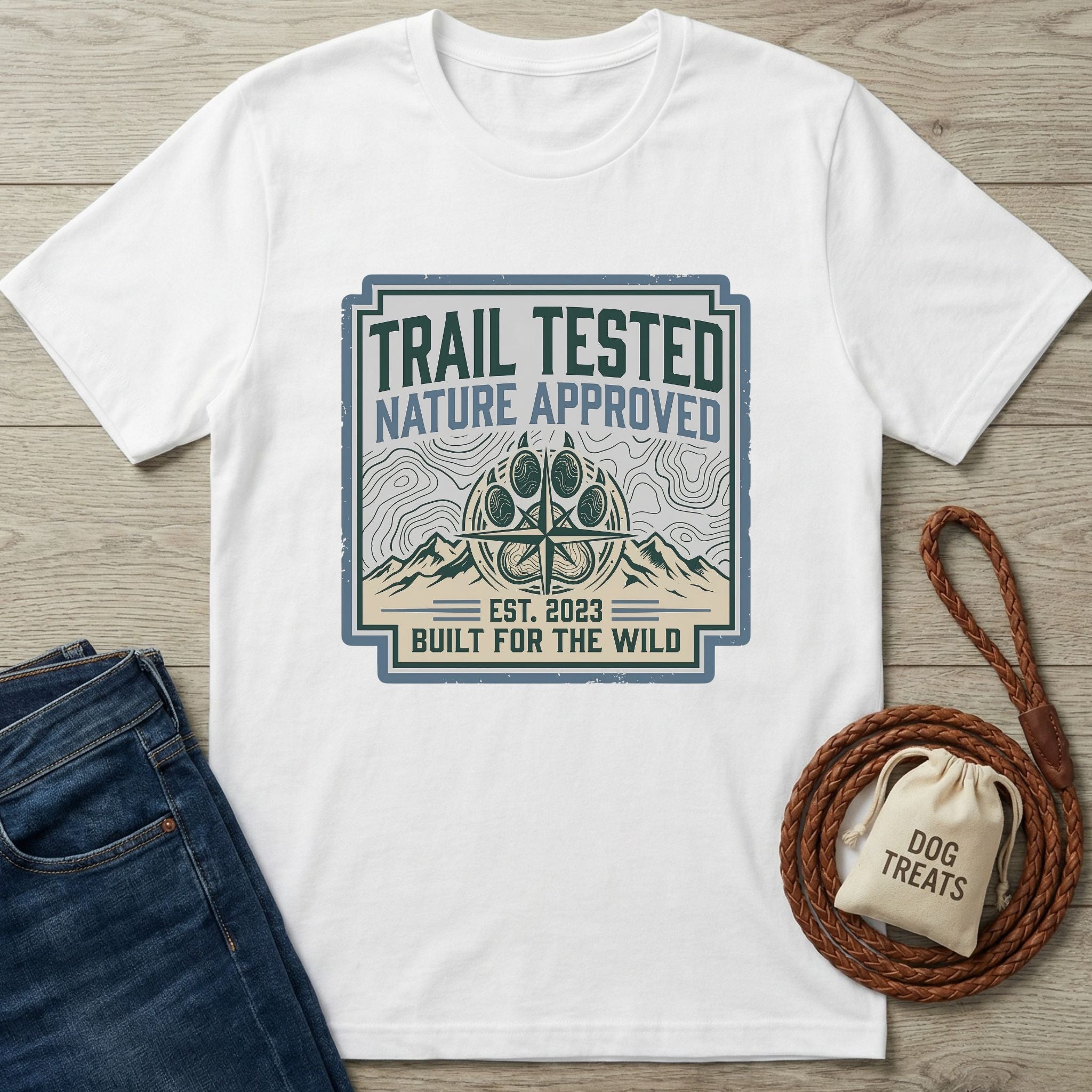 White Gildan Softstyle® t-shirt with "Trail Tested Nature Approved" graphic, paw print compass, and mountains.