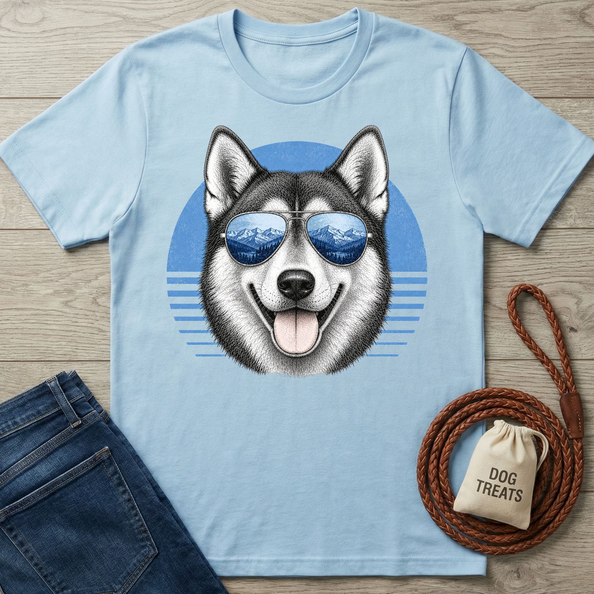 Light blue cotton t-shirt featuring a husky wearing mountain-reflecting sunglasses against a blue circular graphic.