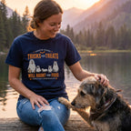 Woman wearing a navy blue crewneck t-shirt featuring a graphic of dogs in ghost costumes with the text Tricks For Treats.