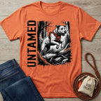 Burnt orange crewneck T-shirt featuring a black and white graphic of a dog jumping over a log with the word Untamed.
