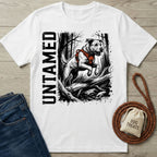 White crew neck t-shirt featuring a black and white illustration of a dog jumping over a log with the word Untamed.