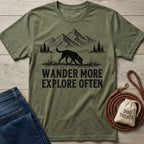Olive green crewneck t-shirt featuring a black mountain and dog graphic with the text Wander More Explore Often.