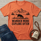 Burnt orange crewneck t-shirt featuring a black graphic of a dog hiking in front of mountains with the text Wander More.