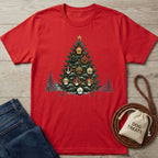 Red crewneck T-shirt featuring a Christmas tree graphic decorated with various dog breed ornaments on a wooden background.