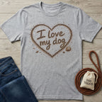 Grey crewneck t-shirt featuring a heart made of sand with the text I love my dog, accented by seashells.